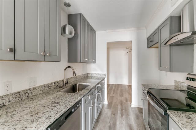 kitchen featuring light stone countertops, wall chimney exhaust hood, stainless steel appliances, sink, and gray cabinets