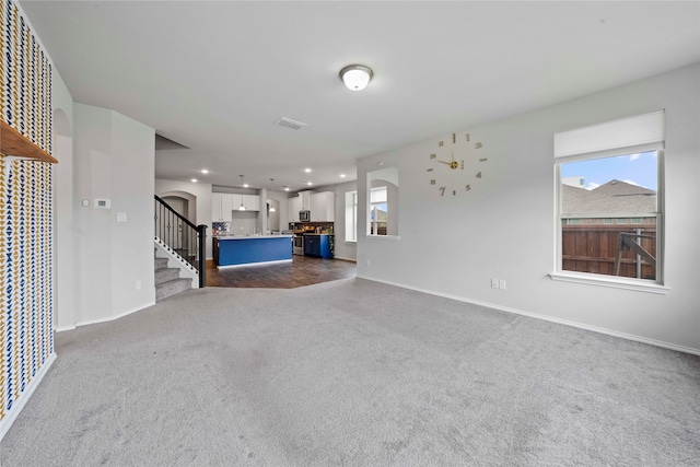 unfurnished living room with carpet