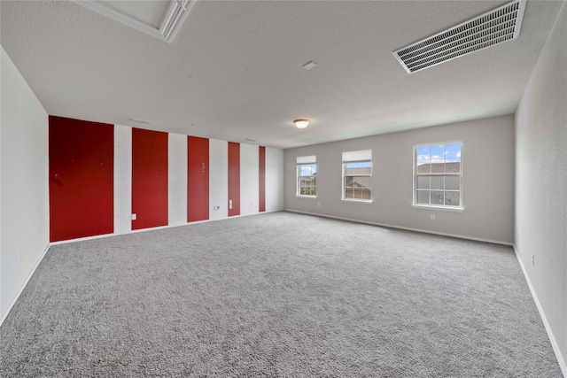 carpeted spare room featuring a textured ceiling