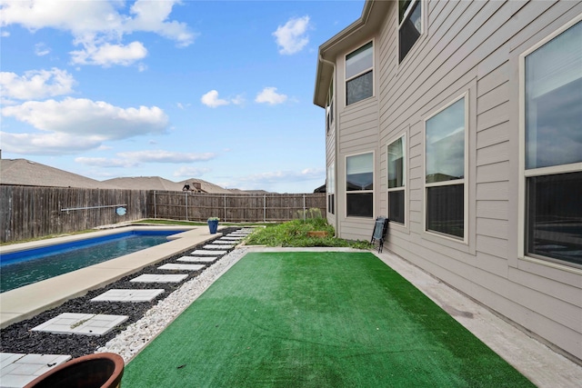 view of yard with a fenced in pool