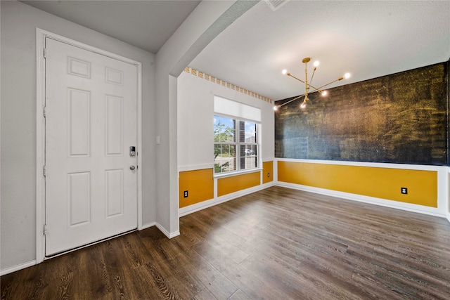 entrance foyer featuring a notable chandelier and dark hardwood / wood-style flooring