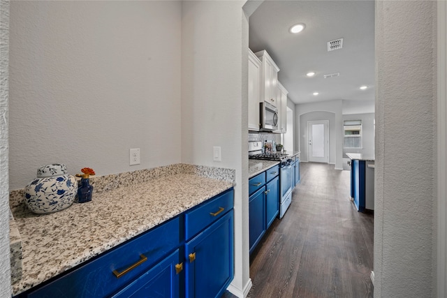 kitchen featuring light stone counters, white cabinetry, dark hardwood / wood-style floors, stainless steel appliances, and blue cabinets