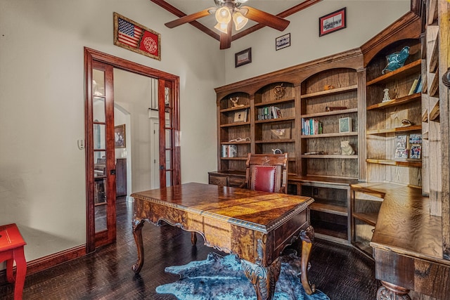 office space with ceiling fan, a towering ceiling, dark hardwood / wood-style floors, and french doors