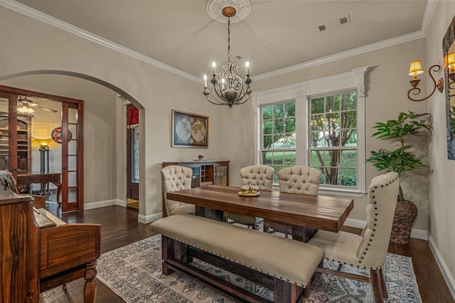 dining space featuring ceiling fan with notable chandelier, dark hardwood / wood-style flooring, and crown molding