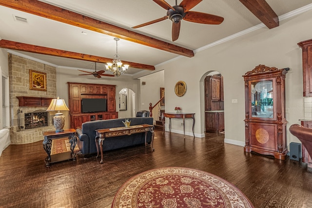 bedroom featuring dark wood-type flooring, beamed ceiling, a stone fireplace, ornamental molding, and a notable chandelier