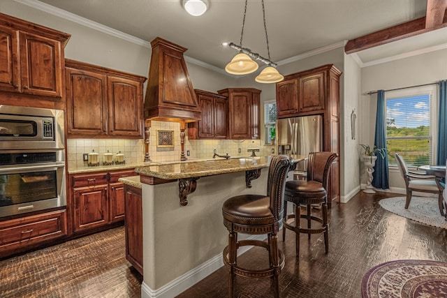 kitchen featuring pendant lighting, a kitchen island, stainless steel appliances, premium range hood, and light stone counters