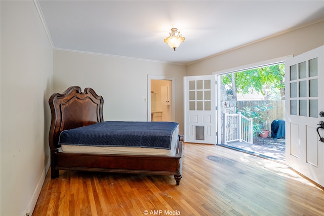 bedroom with crown molding, access to exterior, wood-type flooring, and ensuite bathroom