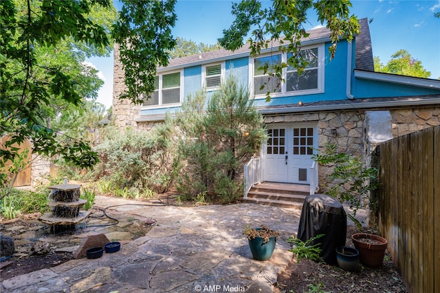 rear view of house with a patio area and french doors