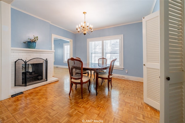 dining space featuring ornamental molding, an inviting chandelier, and a brick fireplace