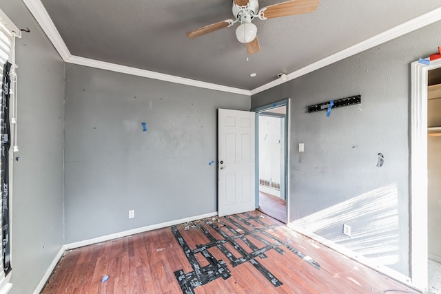 unfurnished bedroom with a textured ceiling, crown molding, ceiling fan, and hardwood / wood-style floors