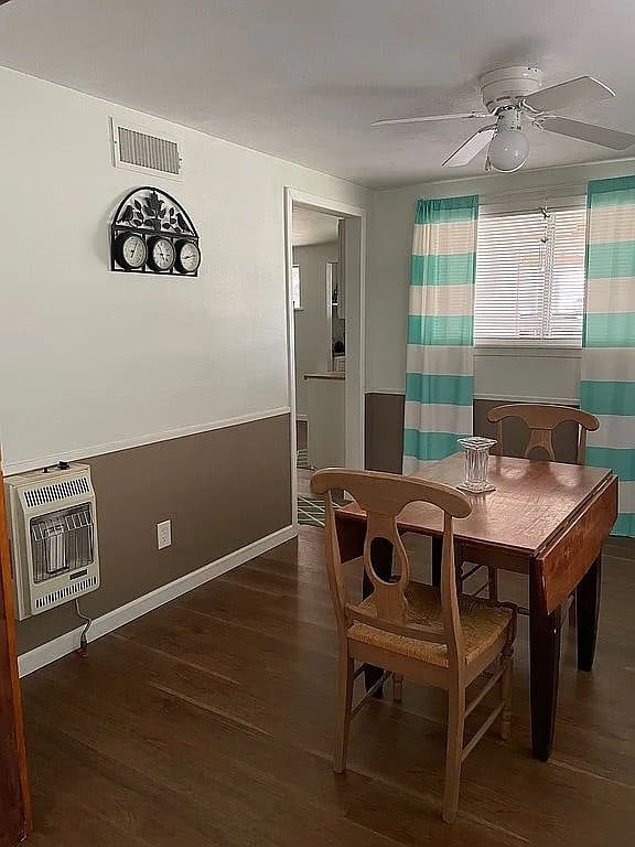 dining space featuring ceiling fan, dark hardwood / wood-style flooring, and heating unit