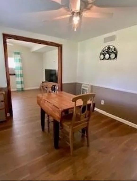 dining room with ceiling fan and dark hardwood / wood-style flooring