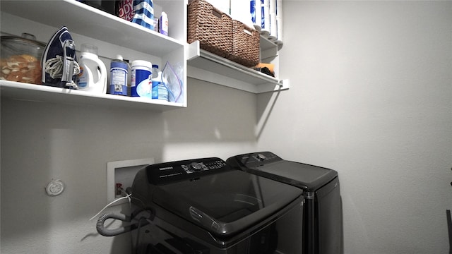 clothes washing area featuring washer and clothes dryer