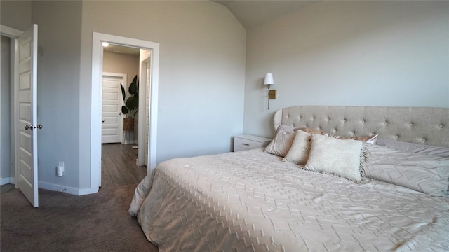 carpeted bedroom featuring lofted ceiling