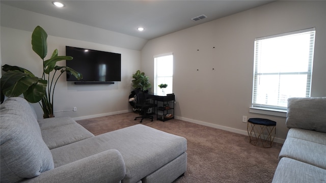 carpeted living room featuring vaulted ceiling and a healthy amount of sunlight