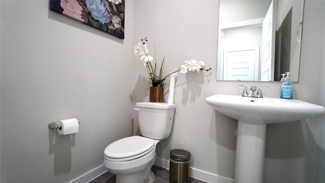 bathroom featuring hardwood / wood-style floors, toilet, and sink