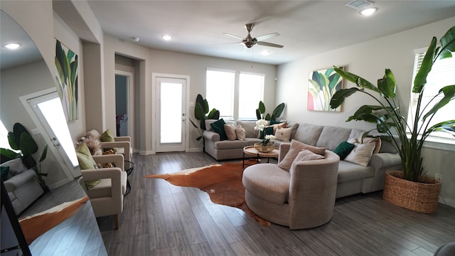 living room with ceiling fan and dark hardwood / wood-style flooring