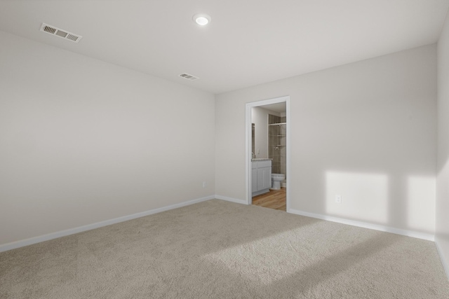 unfurnished room with light carpet