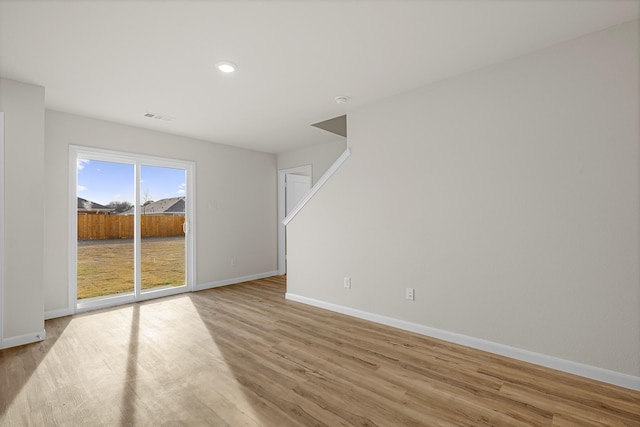 spare room with light hardwood / wood-style floors