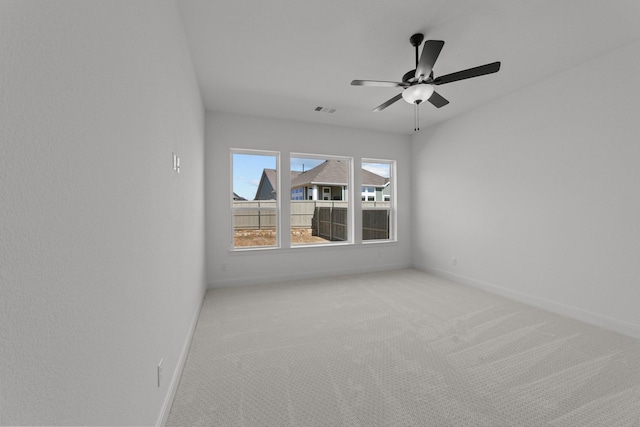 spare room with light colored carpet and ceiling fan