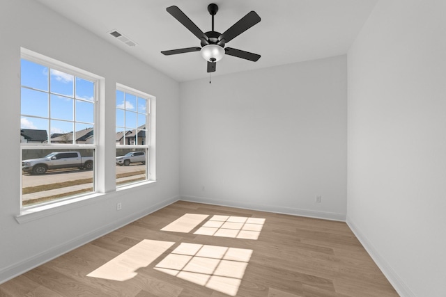 spare room with ceiling fan and light wood-type flooring