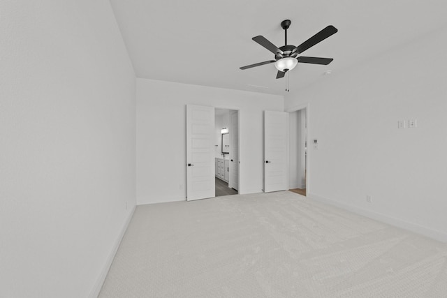 unfurnished bedroom with ensuite bath, ceiling fan, and carpet