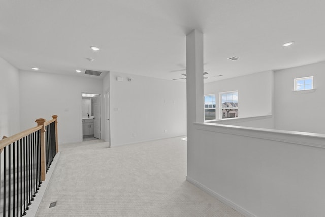 hallway with light colored carpet