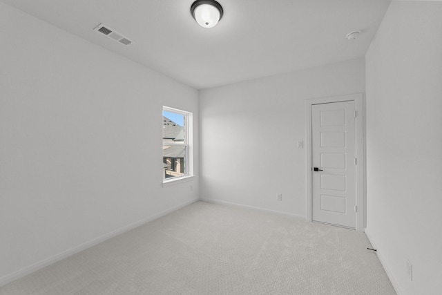 unfurnished room featuring light colored carpet