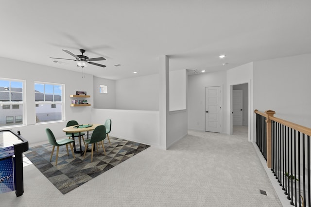 carpeted dining area featuring ceiling fan