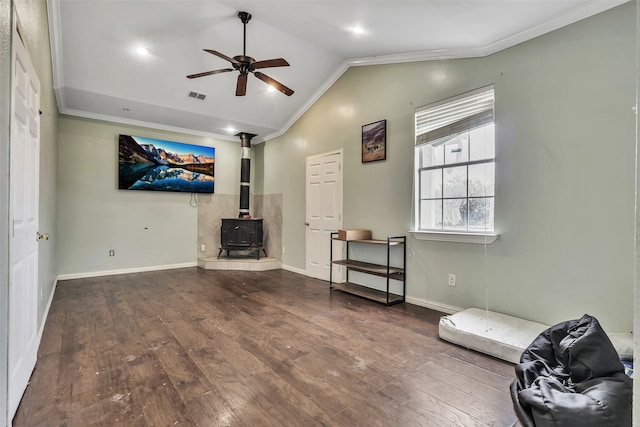 interior space featuring a wood stove, crown molding, ceiling fan, and hardwood / wood-style floors