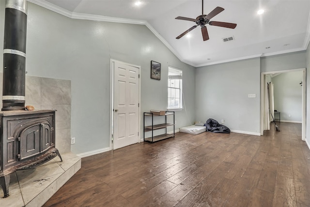 living room featuring crown molding, dark hardwood / wood-style flooring, and a wood stove