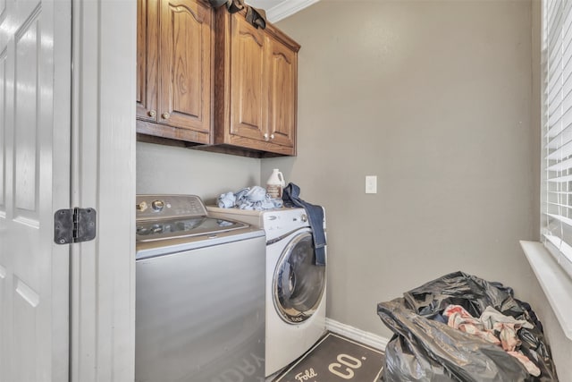 washroom with cabinets, ornamental molding, and independent washer and dryer