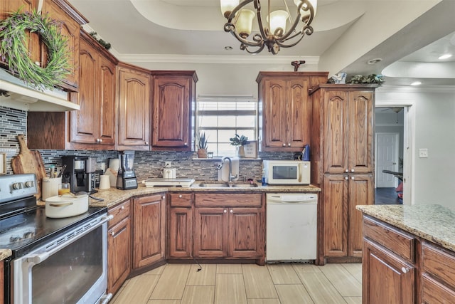 kitchen featuring a notable chandelier, ornamental molding, white appliances, backsplash, and sink