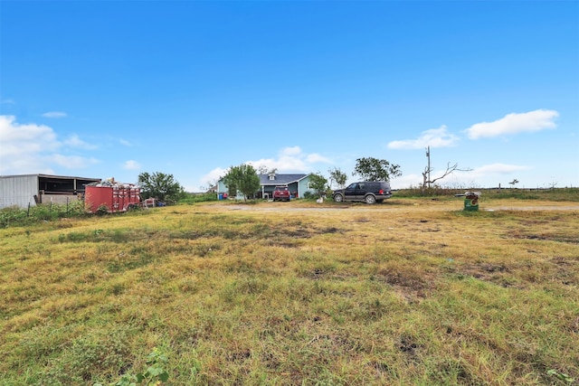 view of yard with a rural view