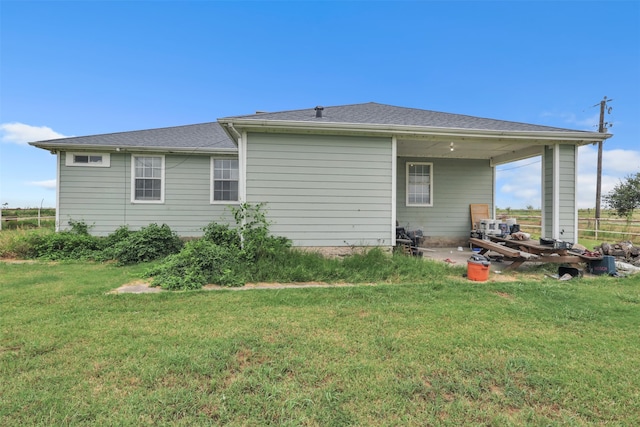 rear view of house with a lawn