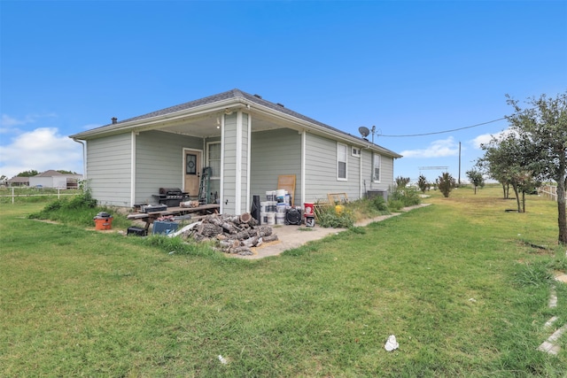 rear view of property with a yard and a patio