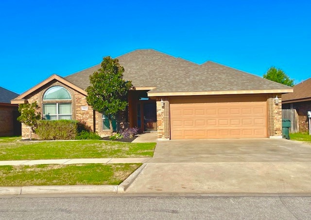 ranch-style home with a front yard and a garage