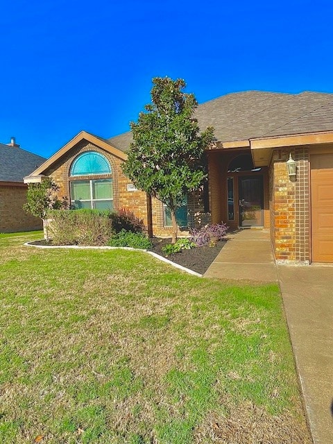 view of front facade with a garage and a front lawn