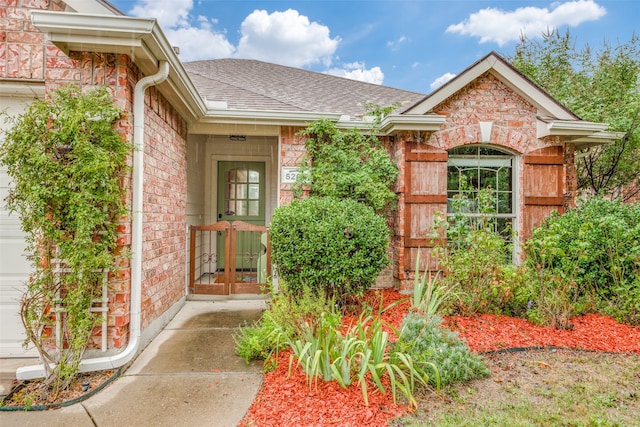 entrance to property with a garage and french doors