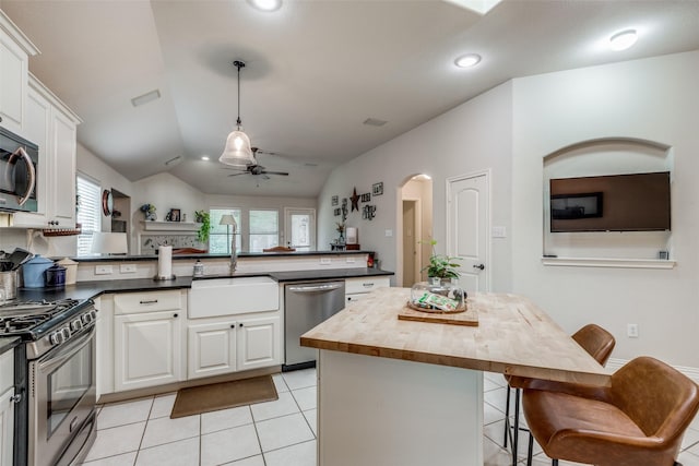 5204 Balsam Dr, Mckinney, TX 75071 - kitchen featuring a sink, butcher block countertops, a peninsula, stainless steel appliances, and ceiling fan