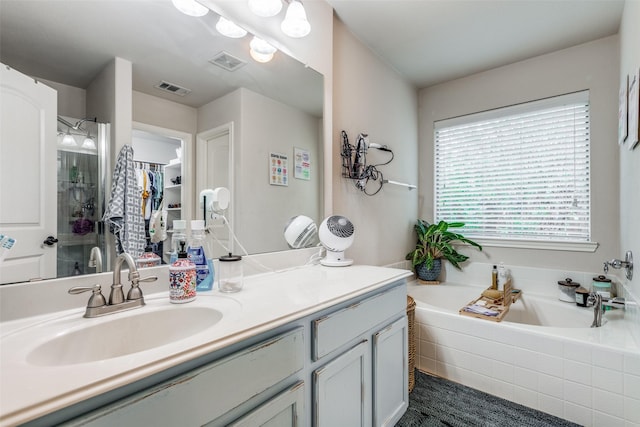 5204 Balsam Dr, Mckinney, TX 75071 - full bathroom with vanity, a bath, a stall shower, and visible vents