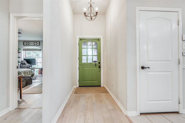 interior space featuring a chandelier, light hardwood / wood-style floors, and a healthy amount of sunlight