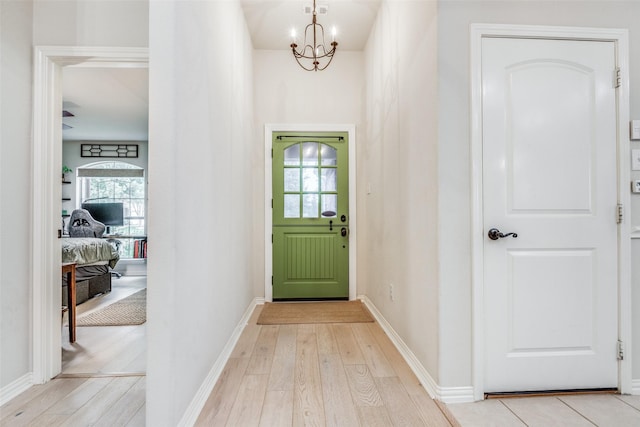 5204 Balsam Dr, Mckinney, TX 75071 - doorway with a wealth of natural light, a notable chandelier, and light wood-type flooring