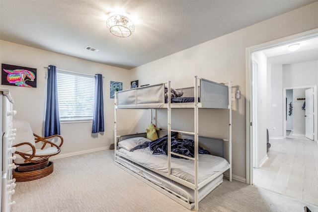 5204 Balsam Dr, Mckinney, TX 75071 - bedroom with light colored carpet, visible vents, baseboards, and a textured ceiling