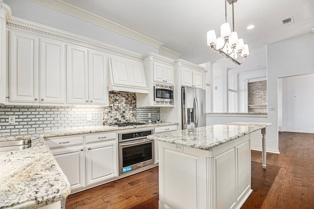 kitchen with pendant lighting, a center island, dark wood-type flooring, white cabinetry, and appliances with stainless steel finishes