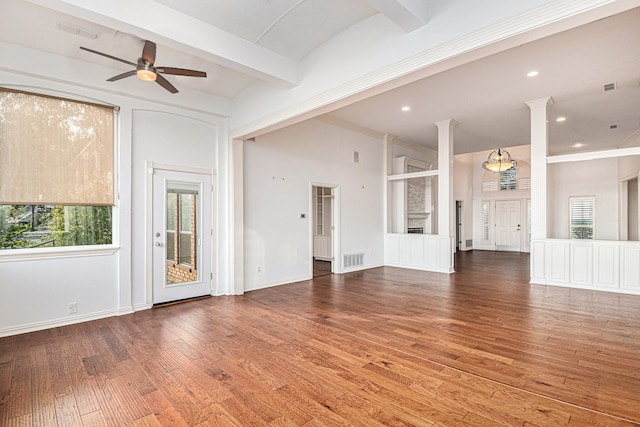 unfurnished living room with wood-type flooring, beamed ceiling, crown molding, ceiling fan, and ornate columns