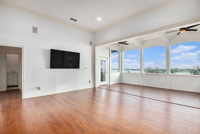 unfurnished living room with wood-type flooring, crown molding, beam ceiling, and ceiling fan