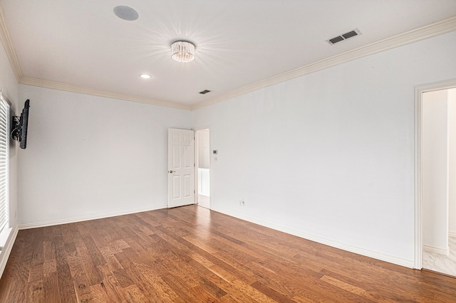 spare room with crown molding and hardwood / wood-style floors