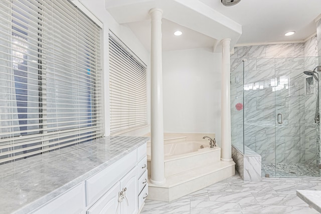 bathroom with shower with separate bathtub, vanity, and ornate columns