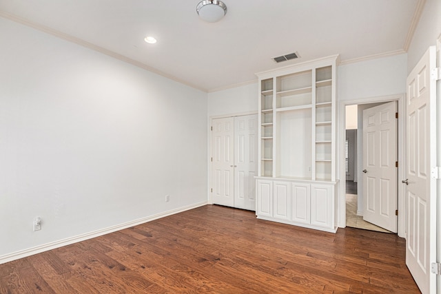 unfurnished bedroom with ornamental molding and dark hardwood / wood-style flooring